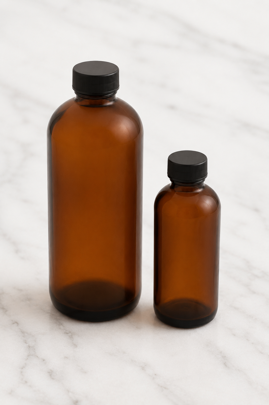 Amber Fragrance Bottles on a Marble Surface