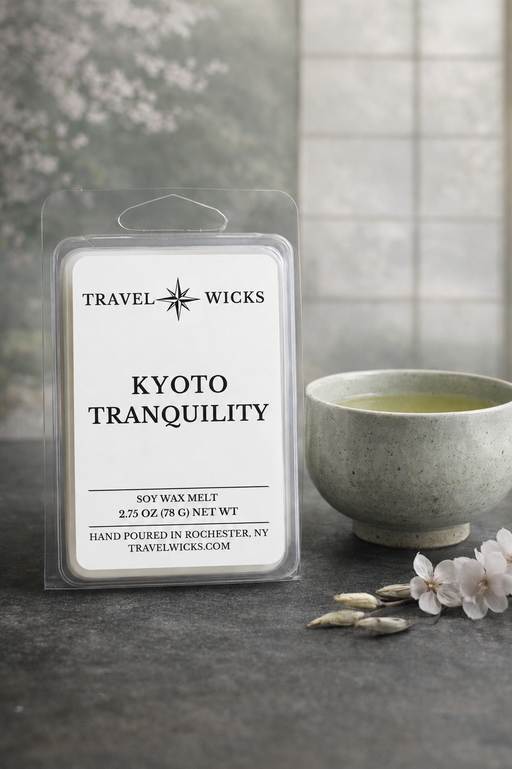 Travel Wicks Kyoto Tranquility wax melt packaging with a cup of tea and flowers on a dark surface.